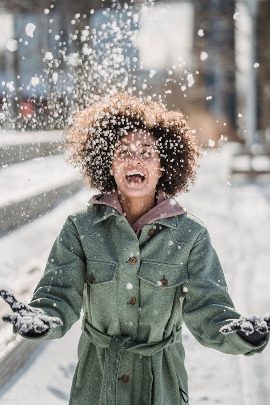 ethnic woman laughing while throwing up snow météo intérieur humeur par la Motivologue