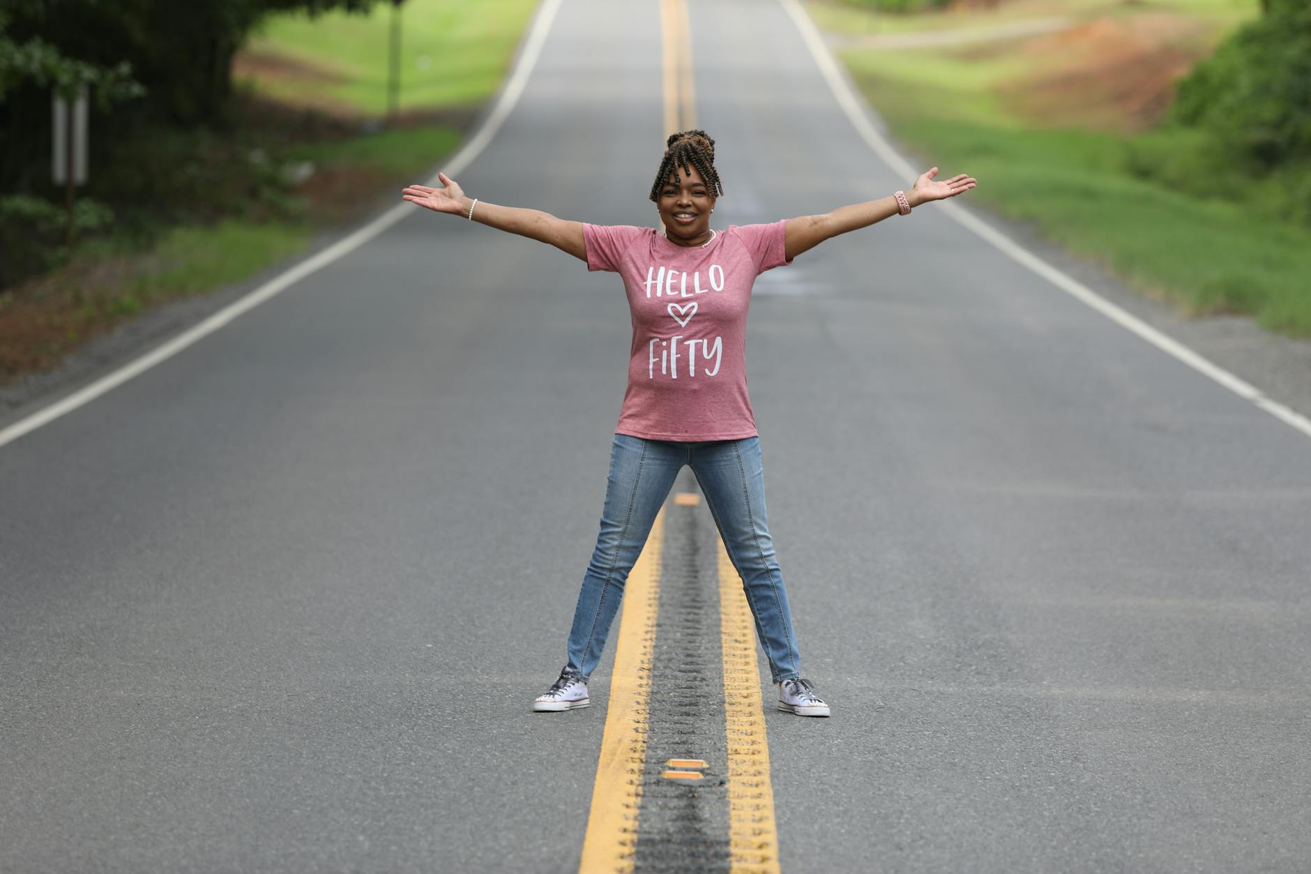 joyful woman celebrating on country road