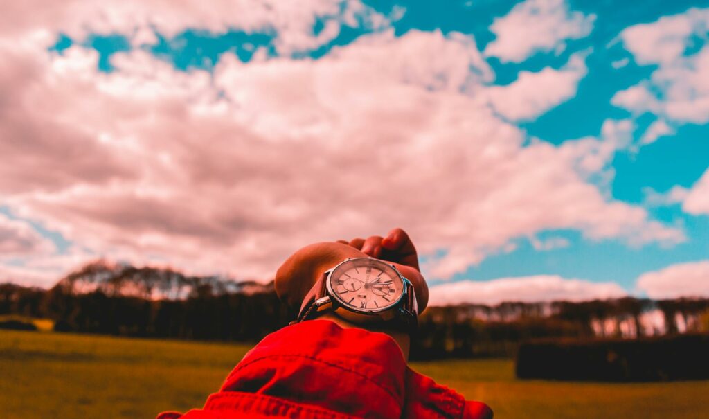 person in red shirt wearing watch
