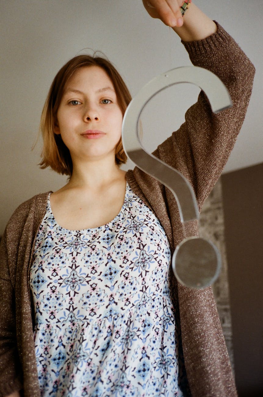 woman holding a glass question mark decor