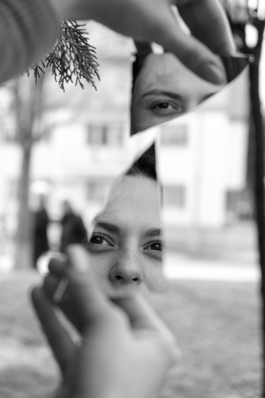 shards of a broken mirror held by a young woman
